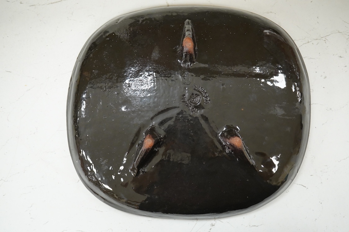 A Joyce Morgan, Chelsea pottery dish depicting a lion and lioness, monogrammed, stamped to the base, 27cm wide